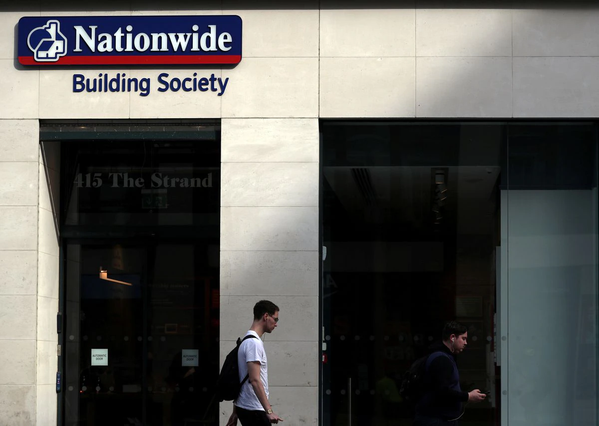 A man walks past a Nationwide Building Society in London