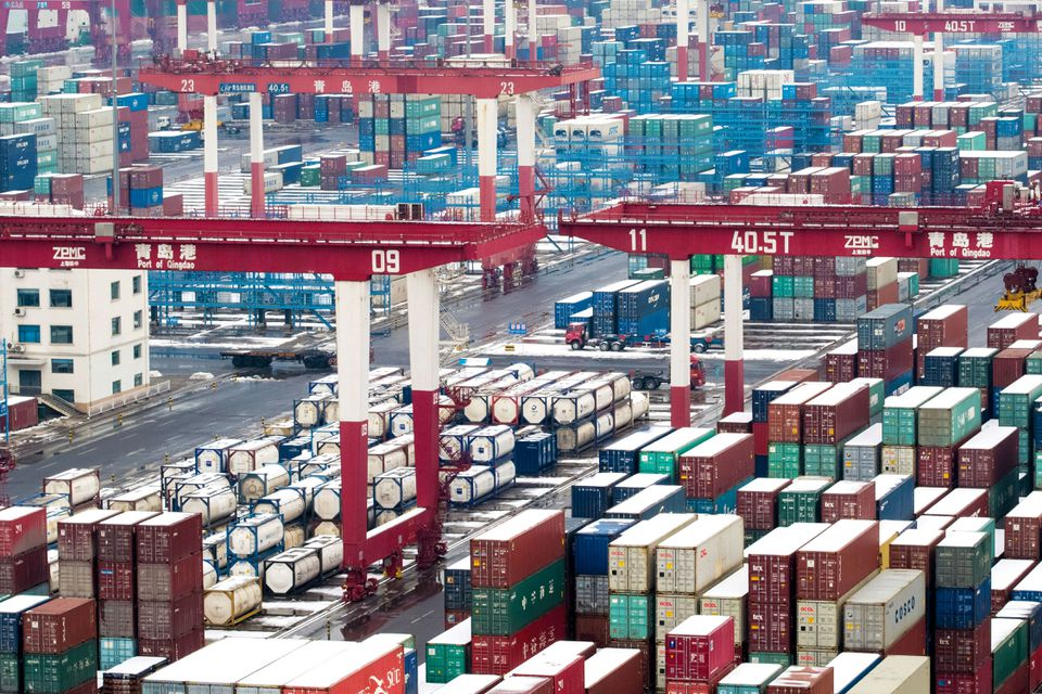 Containers and trucks are seen following a snowfall at the port of Qingdao