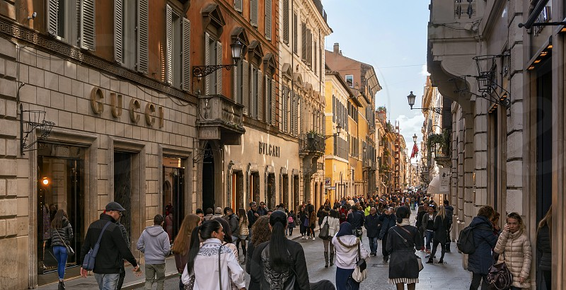 Photo by Valerio Rosati, - people walking the luxury shopping street via  dei Condotti in Rome, Italy